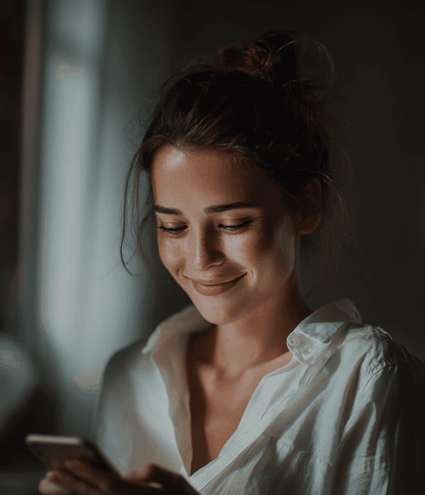 Woman smiling while reading a message
